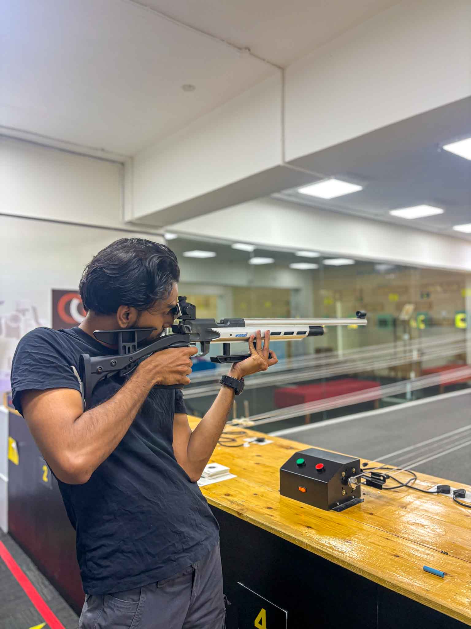A completed shooting target displaying a cluster of bullet holes from a rifle shooting session.